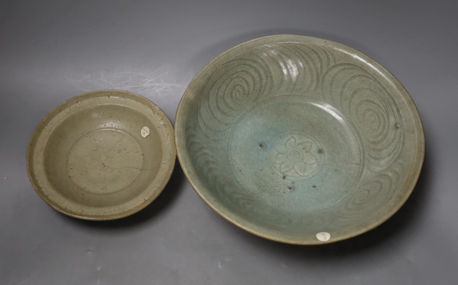 A Chinese celadon dish, probably Southern Song Dynasty, 17.5cm and a Thai Sawankhalok celadon deep dish, 16th century, largest 27cm